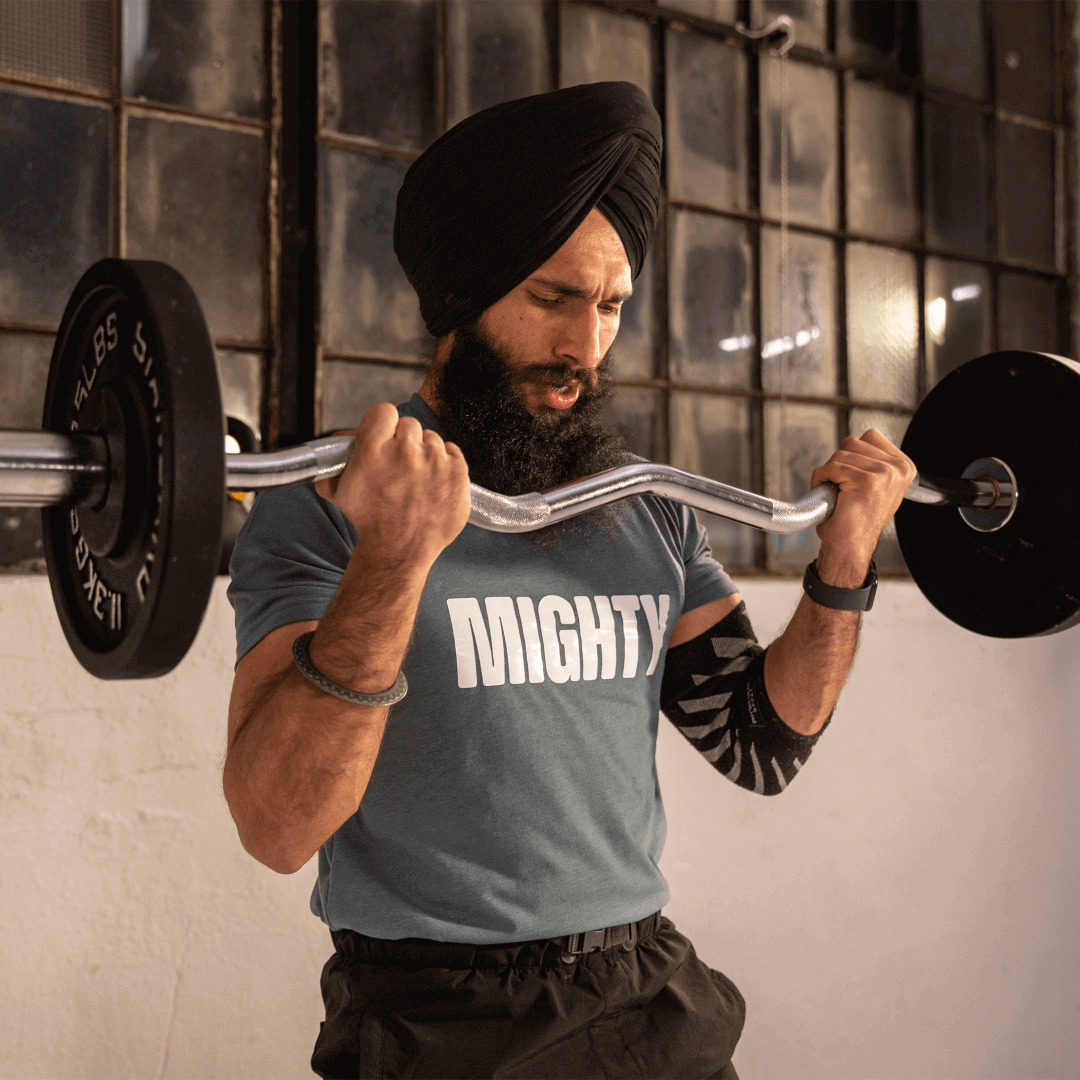 Mighty Fitness Cast Iron Olympic weights Bicep curl with fitness model